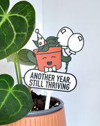 5fef922b396f5759083117ff_another-year-still-thriving-close-up_1781875360591.png